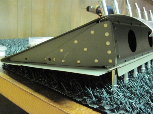 The reinforcing plate at the inboard end of the left flap.