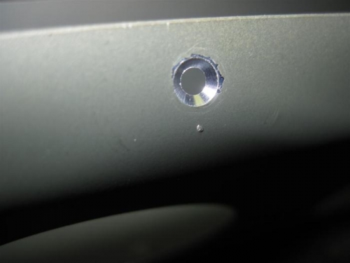 Machine countersunk hole in the flap brace.