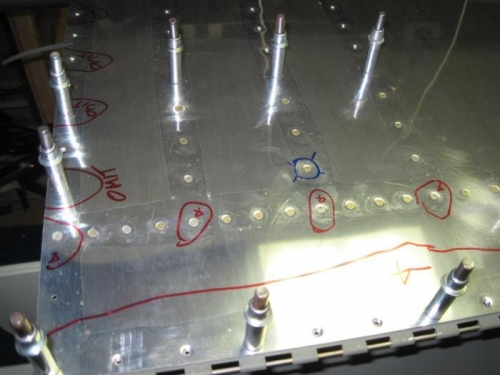 The first rivets in the lower left wing skin.  I will need a helper from here out.  Messed up one.