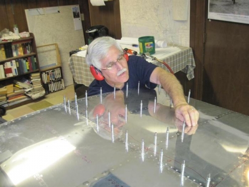 Steve reaching way into the wing to get the bucking bar on the rivet.