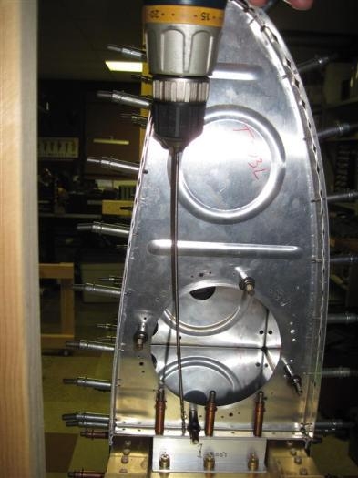 Drilling the inboard rib to the baffle and attach angle.