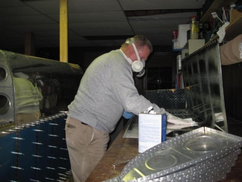 Cleaning the tank skin with acetone.