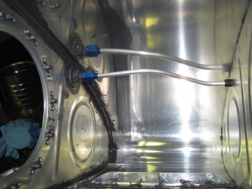 The tank vent line connected to the bulkhead elbow in the inboard rib.
