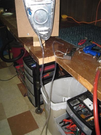 The manometer setup for pressure testing the tank.