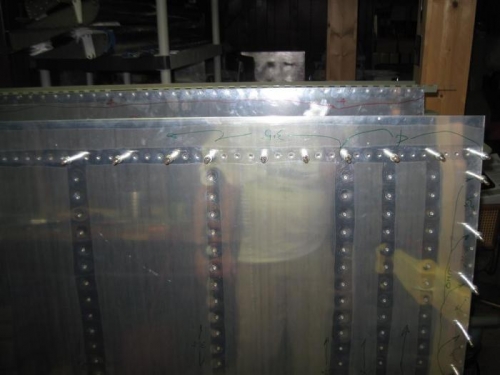 The rest of the trailing edge rivets to be driven later, with a reflection of the hero builder.