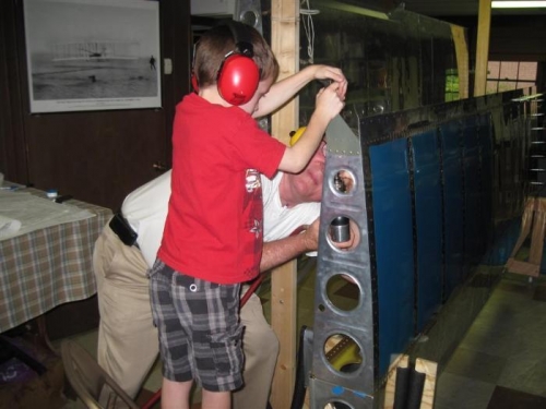 My newest assistant, Dalton, bucking the aileron hinge rivets.