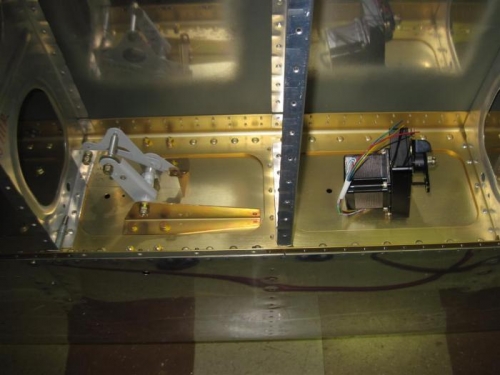 The roll servo removed temporarily from the mount until after the bottom skin is riveted.