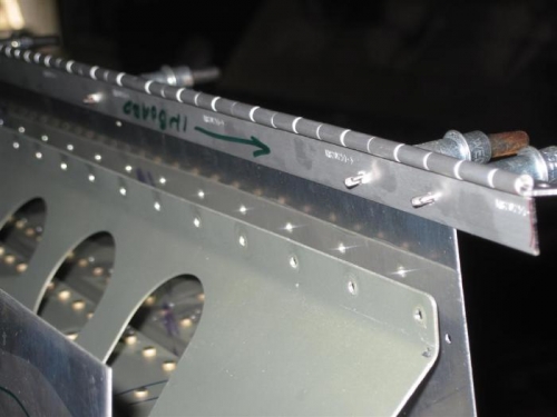 New hinge being drilled to wing skin