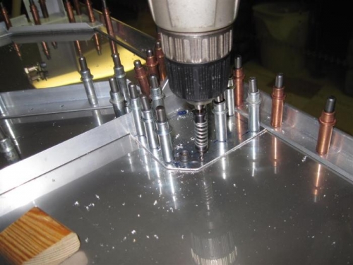 Drilling the fuel pump reinforcing plate to the firewall.