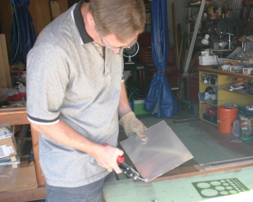 Using Hand Snips to Round Off Corners of Lens Mounting Frames