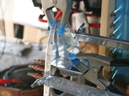 Strut Clamped in Place Between Rib and Bracket