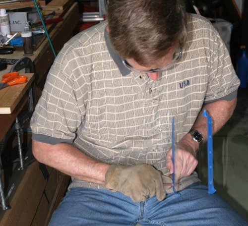 Using Emery Cloth to Slightly Increase Diameter of Fastener Hole in Landing Light Lens