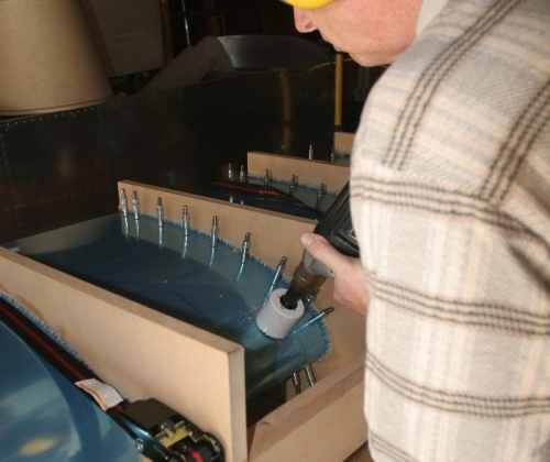 Using the 2-inch Hole Saw to Cut the Lens Cutout Corners