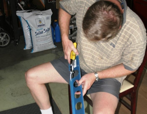 Using Metal Snips to Trim one of the Aft Spar Flap Supports