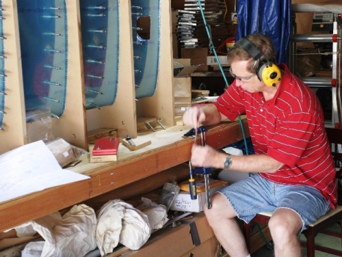 Using Emery Cloth to Remove Burrs from the Stall Warning Switch Adjustment Bracket