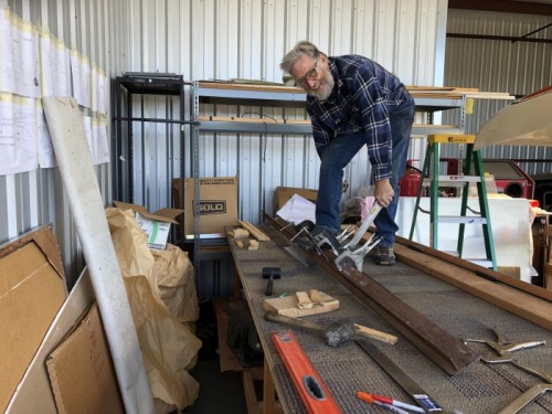 using angle iron and bar stock as an improvised brake to bend the spars.