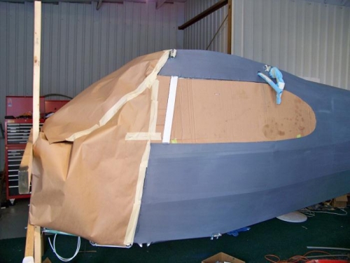 Masking the left side of the fuselage.