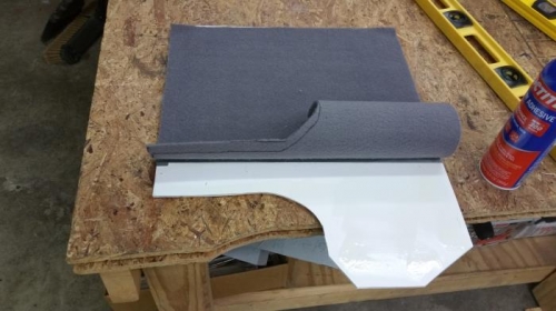 Spray glue holds the carpet and plastic foam board.