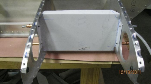 Landing light bracket clecoed to forward ribs.