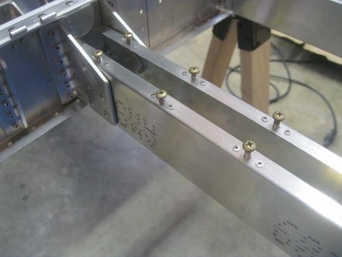 Nutplates riveted with machine screws.