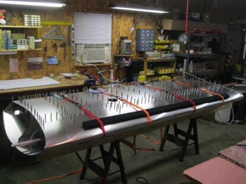 Pulling forward skin into position to drill and cleco.