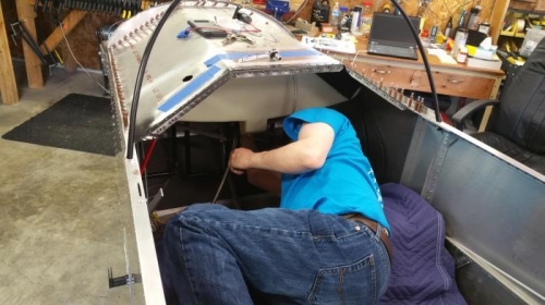 This is Josh getting the tank straps and 10 glareshield nuts tightened down.