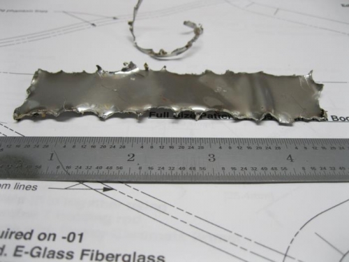 1.5 X 5.0 inch cutout of stainless steel firewall.