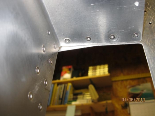 Lookin up at inside of forward tunnel at countersunk rivets.