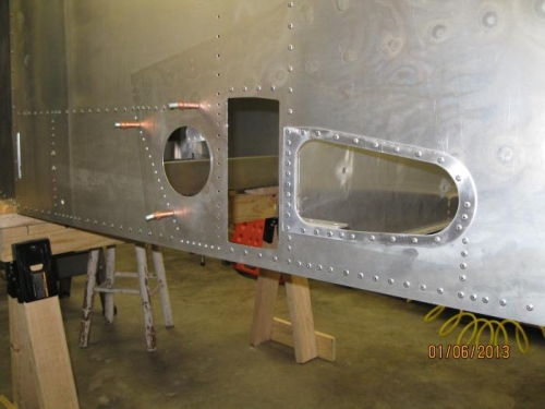 Looking at fuselage side and final riveting of the wing attach angles.