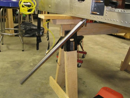 Gear leg positioned through hole in fuselage floor into gear mount.