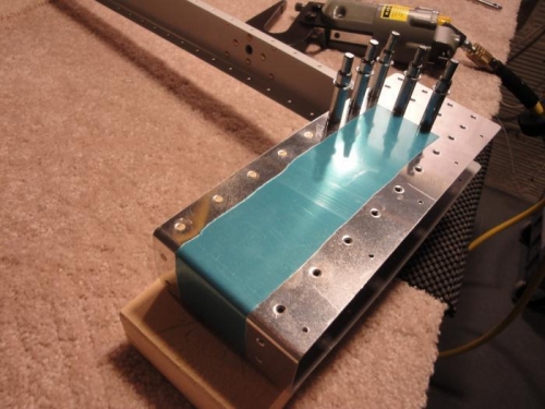 Riveting counter-weight skin to rib and spar