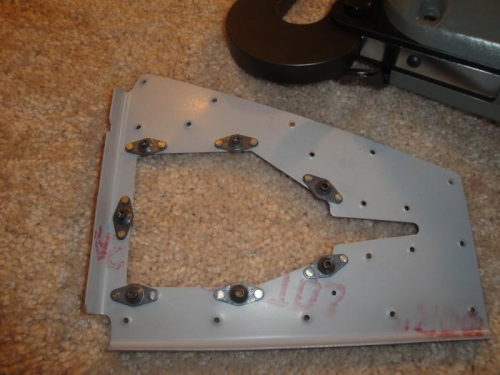 Riveting nut plates to the panel