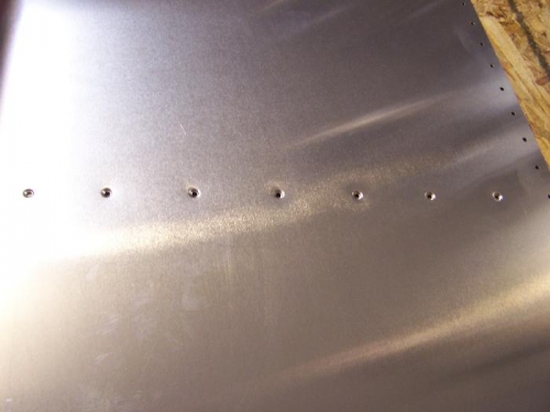 Row of dimpled skin rivets