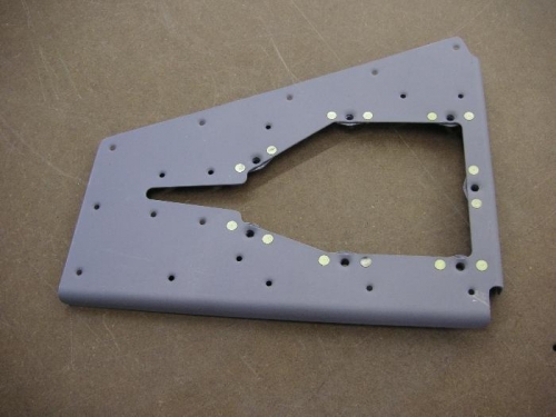 Riveted nut plates on trim reinforcement plate.