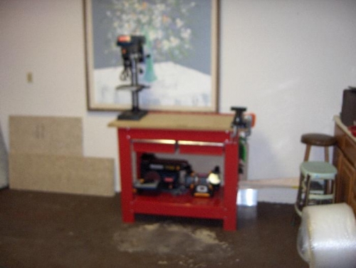A blurry photo of my power tool workbench.