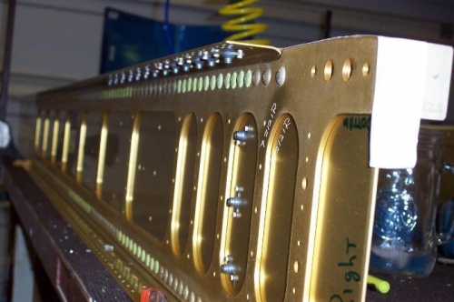 Riveting on the nutplates.  These hold the tank on the wing.