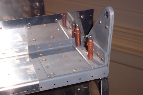 Assembled aileron bracket clecoed in place.