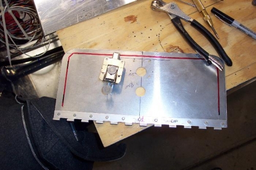 Latch next to access panel.