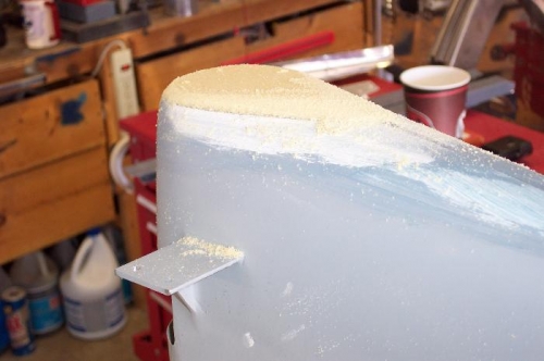 Foam board being shaped down.