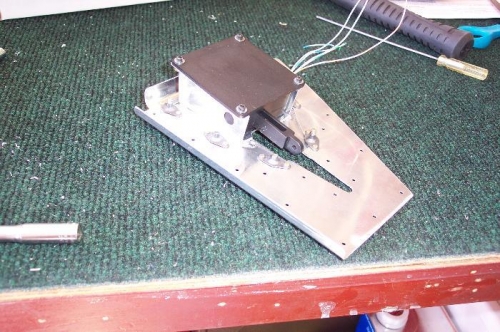 Trim tab servo mounted on the attachment plate.